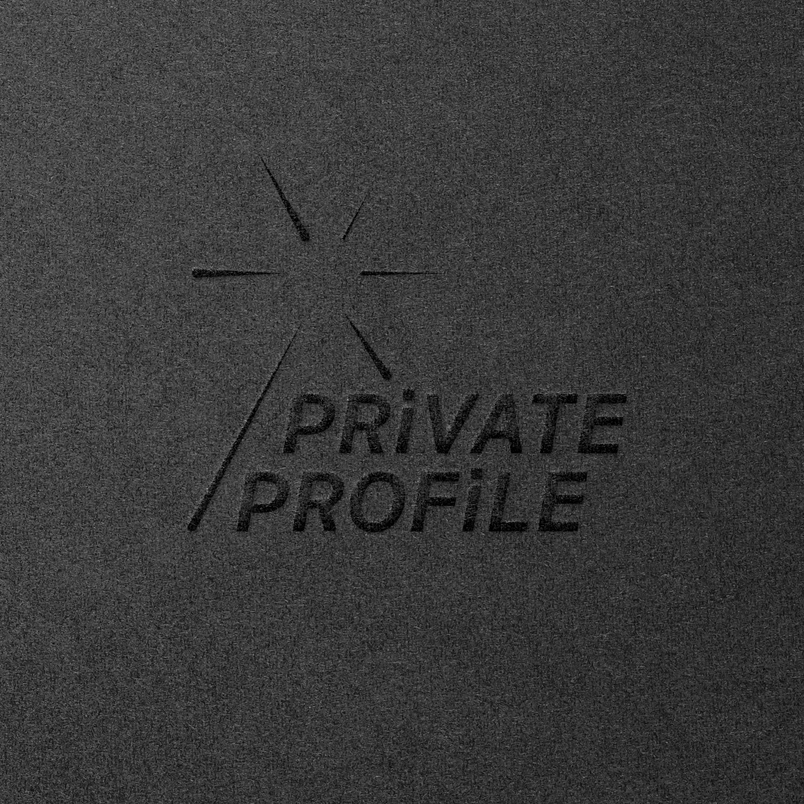 Private Profile embossed logo on black paper